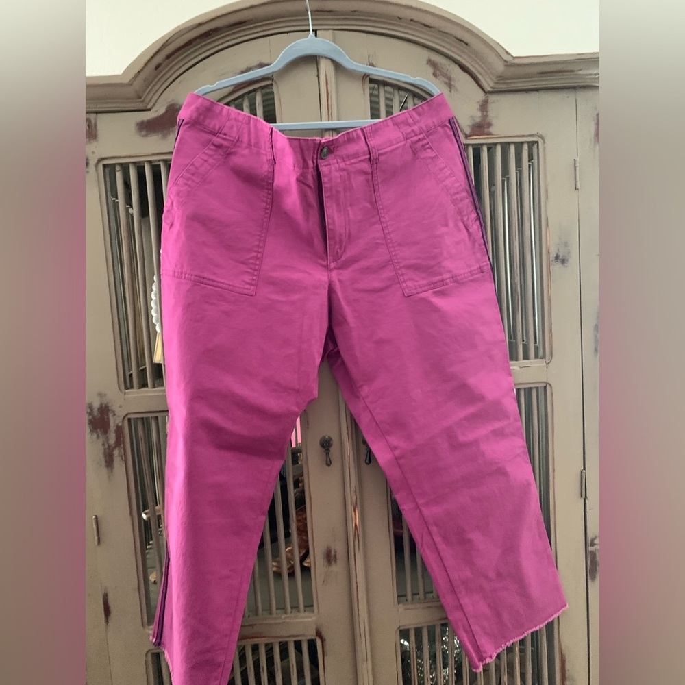 Pink frayed hem pants with black stipe down side of legs